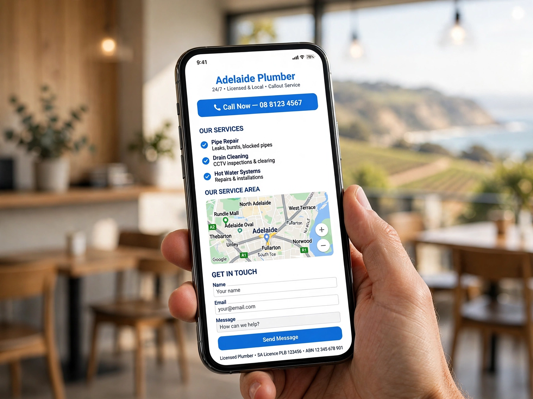 Hand holding a smartphone showing a mobile-optimised one-page website with tap-to-call button and Adelaide map